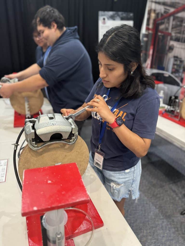 Student engaging in hands-on career simulation as a Biological Technician at BridgeYear’s Career Test Drive® Fair, using tools and equipment in a practical learning environment.