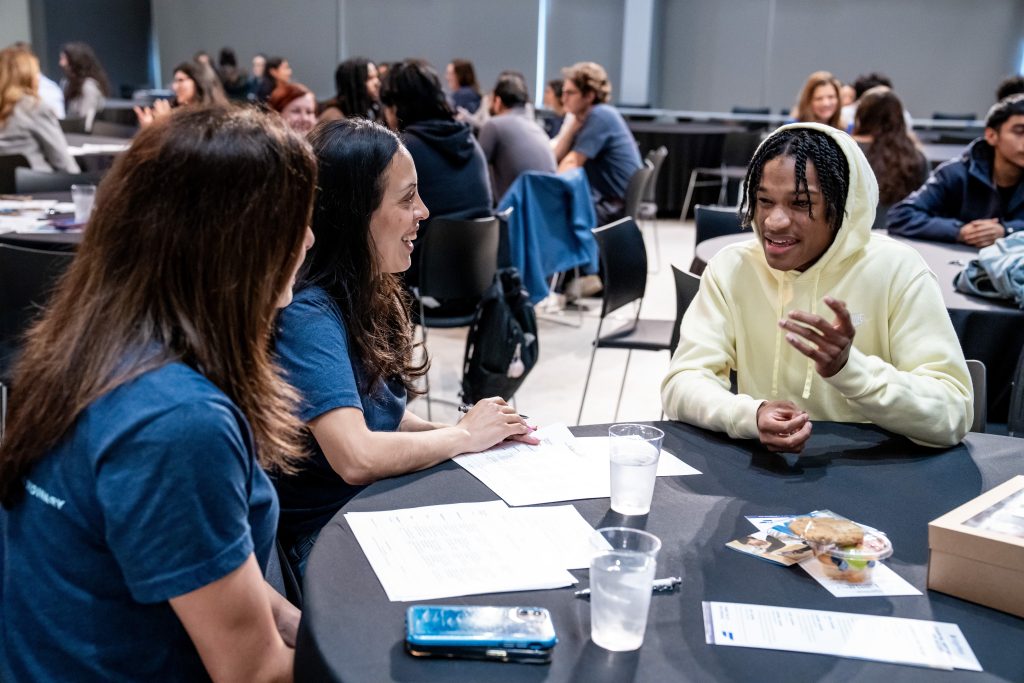 Students engaging in mock interview practice at the ES3 Conference, discussing professional skills with mentors, and enhancing workplace communication abilities.
